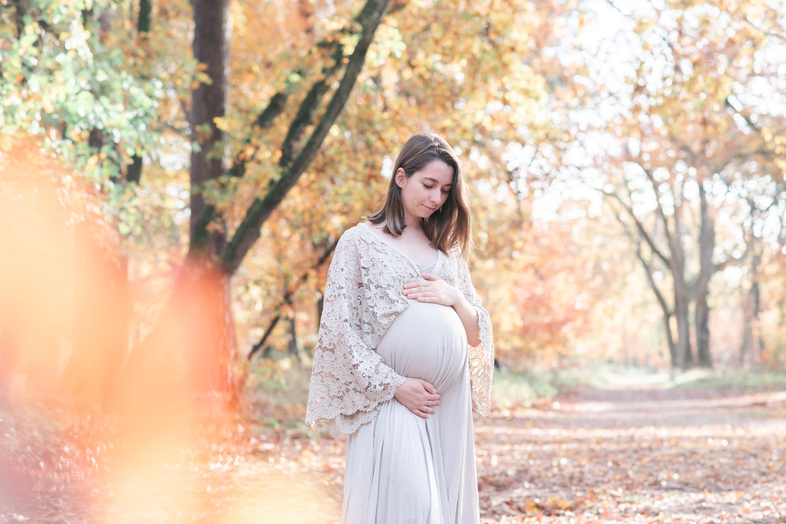 Femme enceinte lors d'une séance photo de grossesse en forêt de Fontainebleau à l'automne